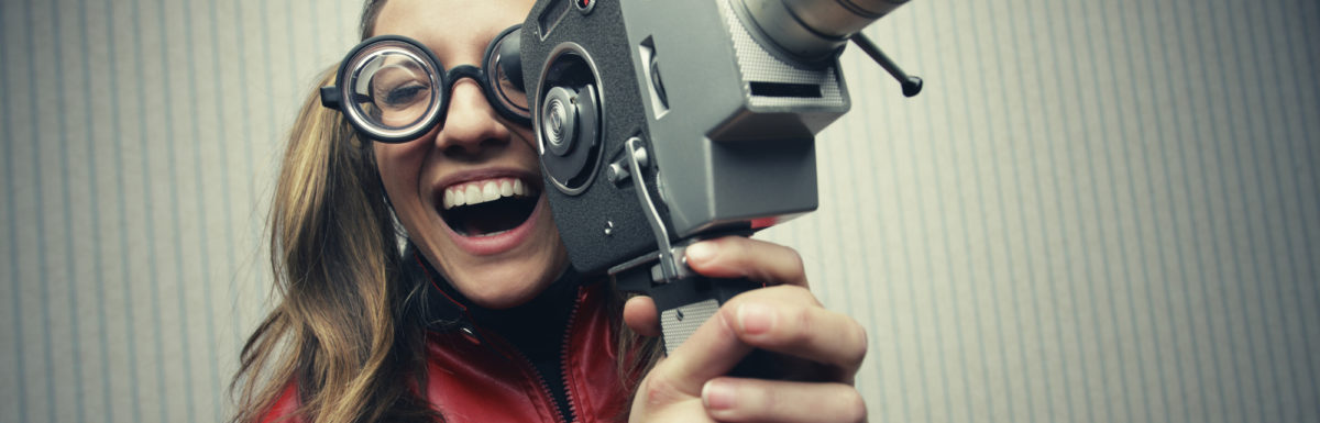 Nerdy woman with old fashion video camera