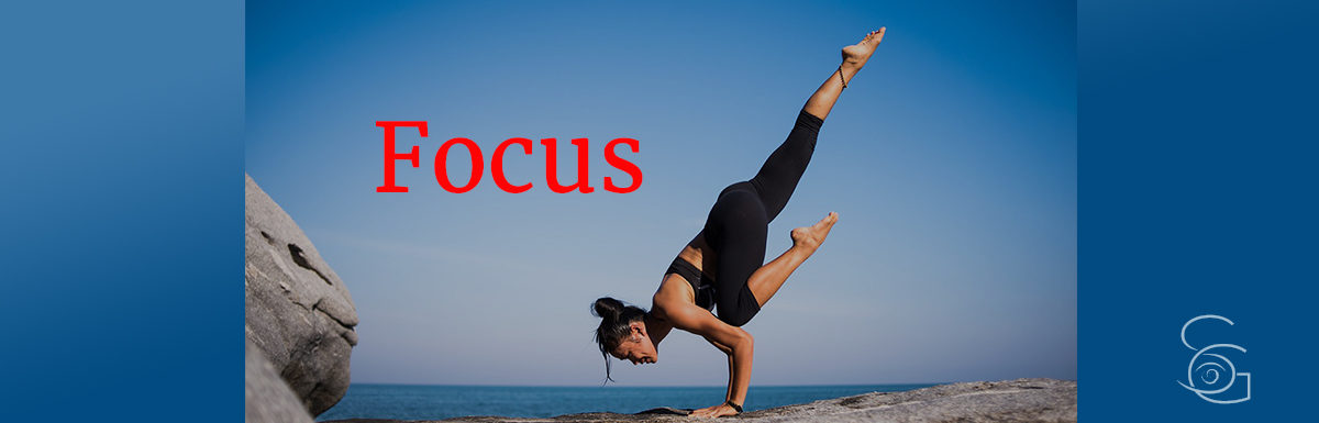 woman in yoga pose by ocean Focus concept